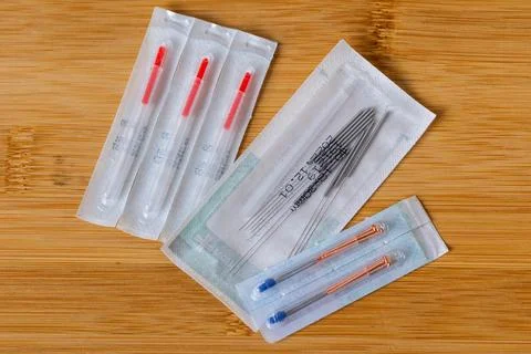 A top down portrait of multiple packages of different acupuncture needles, .. Stock Photos