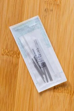 A top down portrait of one package full of tin long acupuncture needles, re.. Stock Photos