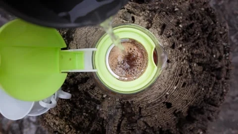 Top down pour of hot water into glass coffee brewer Stock Footage 327013586