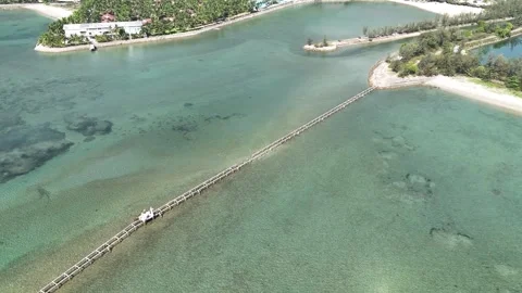 Top-down pullback above turquoise beach and long pier, Nha Trang Stock Footage 340880117