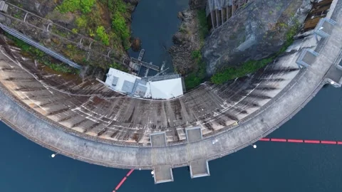 Top-Down Pullback Reveals Lake Kokanee Dam and Rocky Channel Stock Footage 345888178