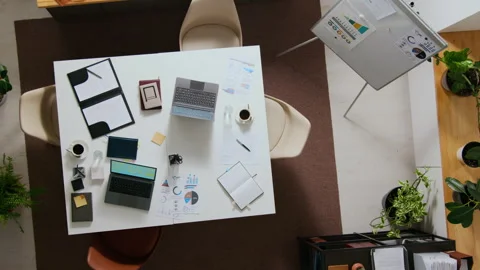 Top Down of Rectangular Office Table with Two Laptops, Documents and Coffee Cups Stock Footage 312447910