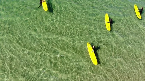 Top down removing aerial shot of surfers in Norway on a sunny day Stock Footage 99241506