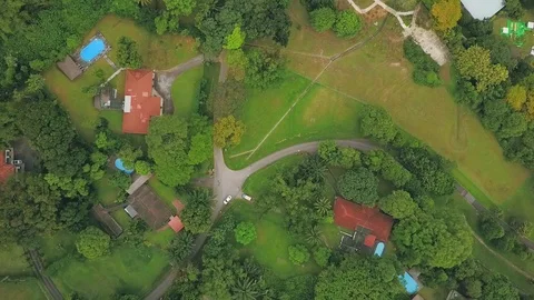 Top-down rotating aerial shot of a park with old houses in the vicinity Stock Footage