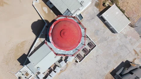 Top-Down Rotating and Ascending Above Lighthouse and Seaside Stock Footage 306259645