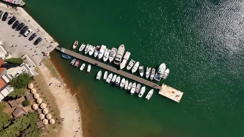 Top-down rotating drone shot of a pier and turquoise water Stock Footage 322045627