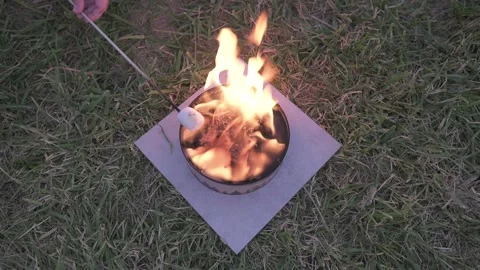 Top down rotating shot of marshmallow being roasted over fire Video stock 142833192