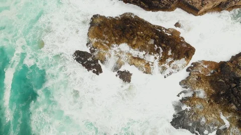 Top down screwdriver aerial view big waves hit rocky desolate ocean coast Stock-Footage 107963473