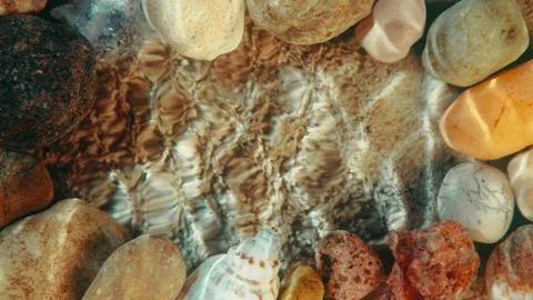 Top down sea floor background, beach sand ripple waves reflection, shells stones Stock Footage 235911275