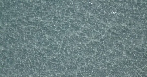 Top-down sea water with light reflections, aerial Stock Footage 111773333