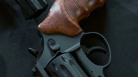 Top down shot of black pistol with brown handle. Close up Stock Footage 168746355