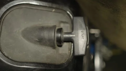 A top-down shot of a black plastic manual pull start handle Vidéo 340820800