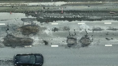 A top-down shot captures an road with visible cracks. Stock Footage 320594225
