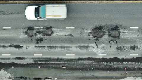 A top-down shot captures an road with visible cracks. Video stock 320594282