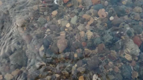 Top-Down Shot of Clear Ripple Water Over Pebble Riverbed Stock Footage 337778648