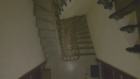 Top down shot going down in a staircase. Spiral stairway interior beautiful Stock Footage 106114199