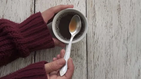 Top down shot hand stirring cup of coffee Stock Footage 142317465