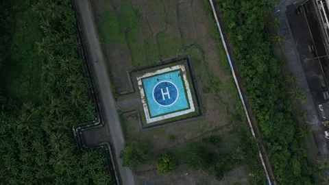 Top-down shot of a helipad with a blue "H" marker. Stock Footage 336749073