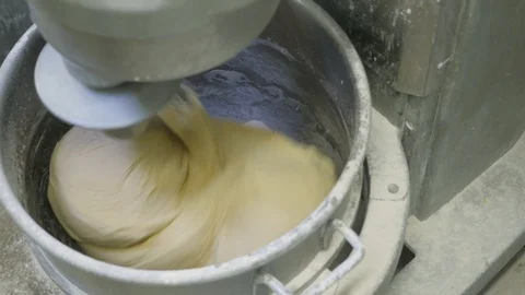 Top down shot of large mixing machine kneading dough Stock Footage 93376707