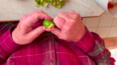Top down shot of a male preparing Brussel sprouts. Stock Footage 321683827
