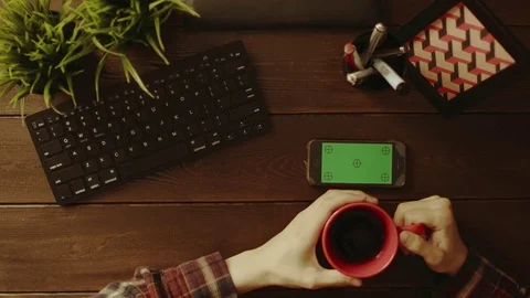 Top down shot of male using smartphone with green screen and drinking coffee Stock Footage 81174496