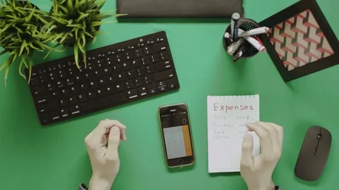 Top down shot of man calculating expenses on his smartphone Stock-Footage 81219066