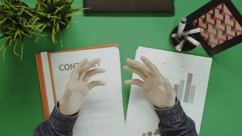 Top down shot of man having a video chat and gesticulating with business papers Stock-Footage 81232040