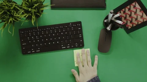 Top down shot of man trying to motivate himself by sticking notes with words "Do Stock-Footage 81232228