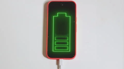 Top Down shot of a Modern Smartphone with Glowing Green Battery Icon Stock Footage 340822077