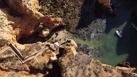 Top down shot of people waiting for boat in Ponta da Piedade Stock Footage 140459946