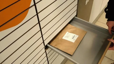 Top Down Shot of Person Retrieving Parcel From Automated Locker Stock Footage 325713982