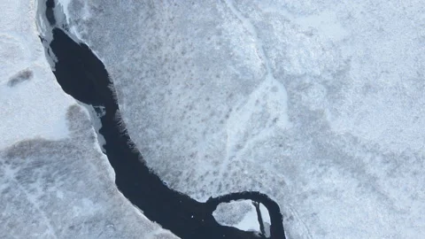 Top Down Shot Of River Flowing Trough Sn... | Stock Video | Pond5