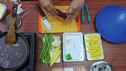 Top-down shot of seasoning raw steak with powdered spices using small spoon Stock Footage 345376738