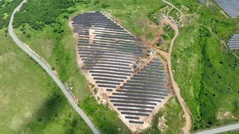 Top-down shot shows solar panels installed on hilly landscape Stock Footage 341731471