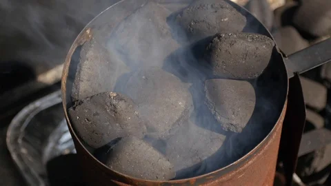 Top down shot of a smoking BBQ chimney Stock Footage 115054326