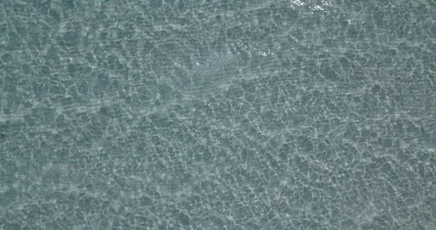 Top-down shot upwards of light reflections in the sea, aerial Stock Footage 111773370