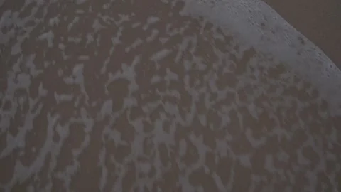 Top down shot of water going over sand Stock Footage 250080847