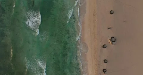 Top down shot of waves breaking on a sandy beach Stock Footage 343622216