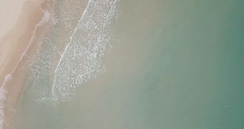 Top-down shot of waves foaming and crashing on empty beach, aerial Stock Footage 111775879
