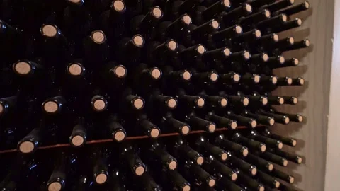 Top down shot of wine bottles stacked on a rack in a wine cellar Stock Footage 155639499