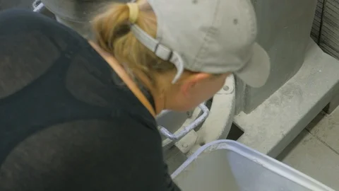 Top down shot of woman adding flour to dough machine mixing Video stock 93376845