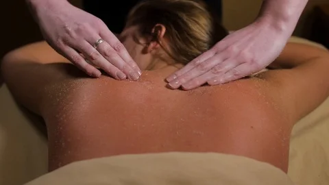 Top down shot of a womans back with a salt body scrub just hands and back Stock-Footage 86817175