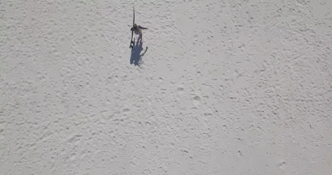 Top-down shot of a young woman running with surfboard Stock Footage 111772753