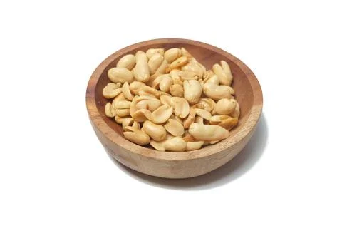 Top-down, slightly angled view of a small, rustic wooden bowl filled with r.. Stock-Fotos