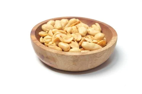 Top-down, slightly angled view of a small, rustic wooden bowl filled with r.. Stock-Fotos