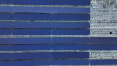 Top down solar farm rows under construction with lateral motion pattern Stock Footage 334351128
