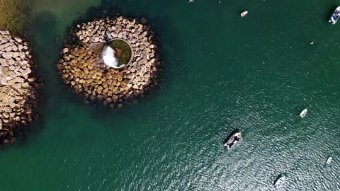 Top down spiral aerial view of geyster at Old Beach at Paco de Arcos bay in Stock Footage 202132944