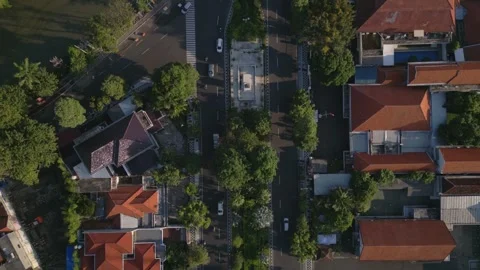 Top down street view of tree lined avenue and bridge in downtown Surabaya Stock Footage 338038910