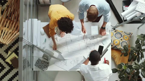Top Down of Team of Diverse Architects Working Together on Floor Plan Stock Footage 139380984