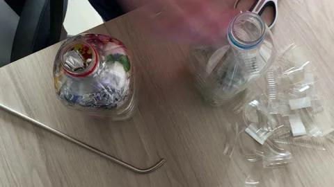 Top down timelapse of filling two eco bricks Stock Footage 160124998